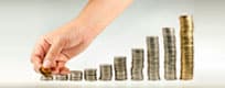 Increasing stacks of coins representing growing wealth with expert wealth management guidance